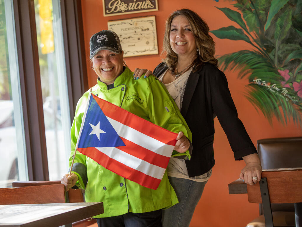 El Coqui co-owners Chef Jackie Roman and Tina Jackson pause in the dinning room of their downtown Santa Rosa restaurant on Mendocino Avenue, Monday, April 17, 2023. (Chad Surmick / The Press Democrat)