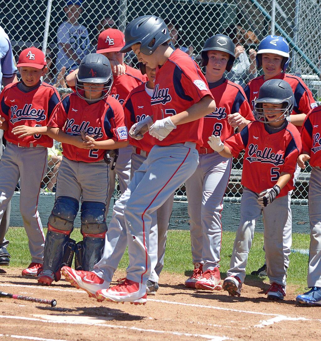 SUMER FOWLER FOR THE ARGUS-COURIERJaden Julian jumps on home plate after his first-inning home run gave the Petaluma Valley's Athletic Edge a quick lead in city championship game it won, 12-2, over the Nationals' Elks Lodge No. 901.