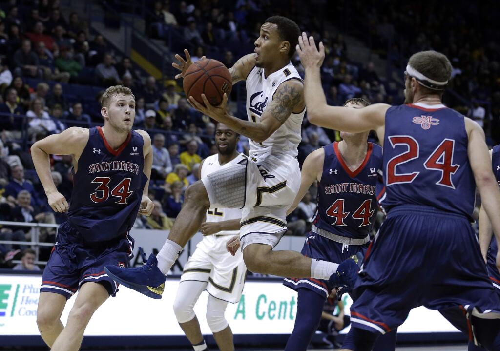 Cal's Don Coleman, center, drives past Saint Mary's Jock Landale (34) and Cullen Neal (44) during the first half Saturday, Dec. 2, 2017, in Berkeley. (AP Photo/Ben Margot)