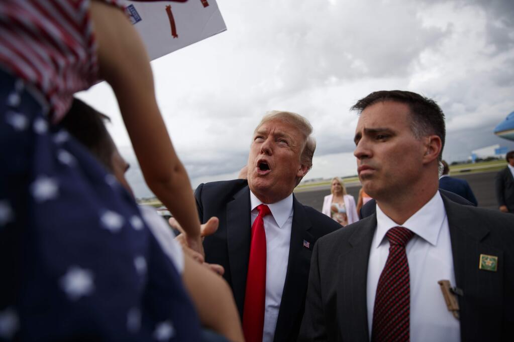 President Donald Trump talks with supporters after getting off Air Force One at Tampa International Airport, Tuesday, July 31, 2018, in Tampa, Fla. (AP Photo/Evan Vucci)