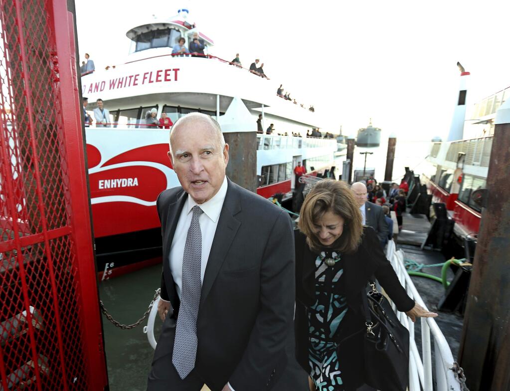 California Gov. Jerry Brown, and his wife, Anne Gust Brown, leave the high-tech battery-operated San Francisco Bay sightseeing boat, Enhydra, after taking a short cruise where he signed 16 new laws aimed at easing global warming, Thursday, Sept. 13, 2018, in San Francisco. (AP Photo/Rich Pedroncelli)