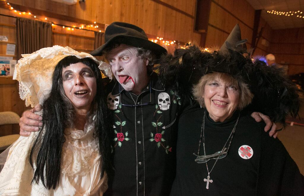 Karol Kopley, left, Jim Corbett, AKA Mr. Music, center, and Gail Thomas attend a Zombie Ball benefit for Palm Drive Health Care Foundation at the Sebastopol, Calif., Community Cultural Center Friday, October 31, 2014.
