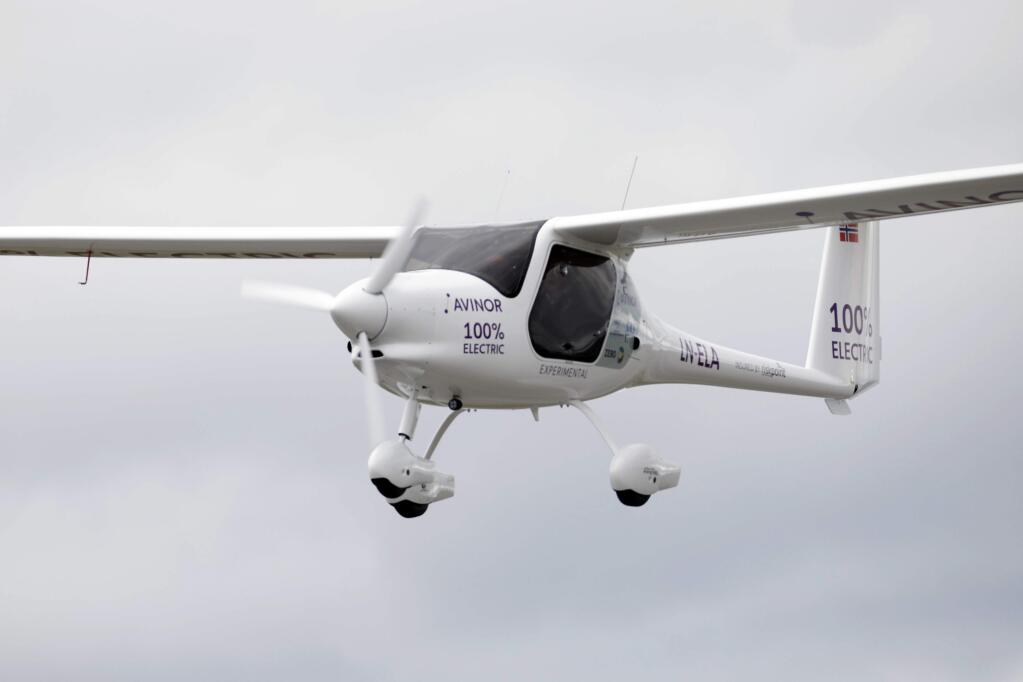 A view of the first flight by an electric aircraft, at Olso Airport, in Gardermoen, Norway, Monday, June 18, 2018. Norway's transportation minister and the head of the Scandinavian country's airport operator took off Monday for a short flight ... aboard a small, Slovenian-made two-seater electric airplane. Dag Falk-Petersen, head of Avinor, sat at the commands of the white Pipistrel Alpha Electro G2 while Ketil Solvik-Olsen sat in the passenger seat when they took off from a remote corner of the Oslo airport for a brief journey in the grey skies. (Gorm Kallestad/NTB scanpix via AP)