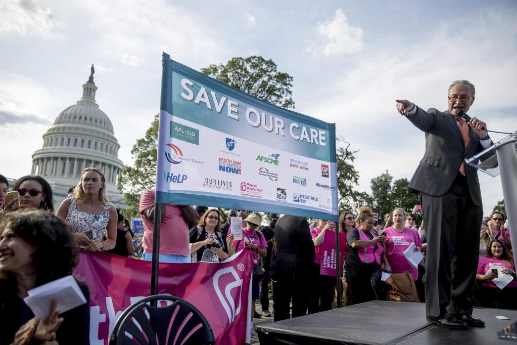 Senate Minority Leader Sen. Chuck Schumer of N.Y., speaks to a large group of protesters at a rally against the Senate GOP healthcare bill on the East Front of the Capitol Building in Washington, Wednesday, June 28, 2017. (AP Photo/Andrew Harnik)