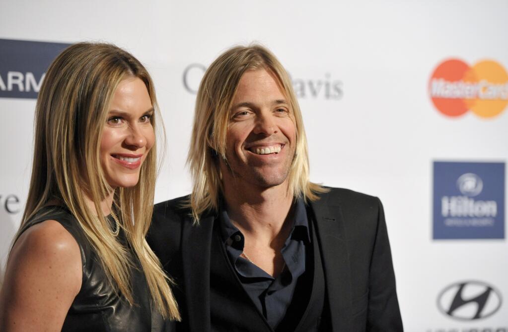 FILE - Foo Fighters drummer Taylor Hawkins, right, and Alison Hawkins arrive at the Clive Davis Pre-GRAMMY Gala on Saturday, Feb. 9, 2013, in Beverly Hills, Calif. Hawkins, the longtime drummer for the rock band Foo Fighters, has died, according to reports, Friday, March 25, 2022. He was 50. (Photo by John Shearer/Invision/AP, File)