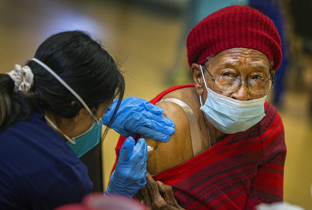 Sammie Williams, 90, receives her first COVID-19 vaccination shot at a clinic for seniors over 75 years old at the Rohnert Park Community Center on Wednesday, January 27, 2021.  (Photo by John Burgess/The Press Democrat)