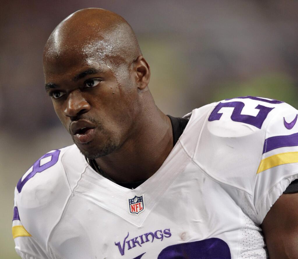 In this Sept. 7, 2014, file photo, Minnesota Vikings running back Adrian Peterson warms up for an NFL football game against the St. Louis Rams in St. Louis. (AP Photo/Tom Gannam, File)