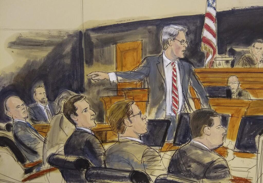 In this courtroom sketch, Assistant U.S. Attorney Robert Sobelman, standing, points to Michael Avenatti, far left, as he makes opening remarks during trial in New York, Wednesday Jan. 29, 2020. A prosecutor kicked off opening statements at Avenatti's attempted extortion trial by saying the deep-in-debt California lawyer tried to extort Nike to line his pockets. (Elizabeth Williams via AP)
