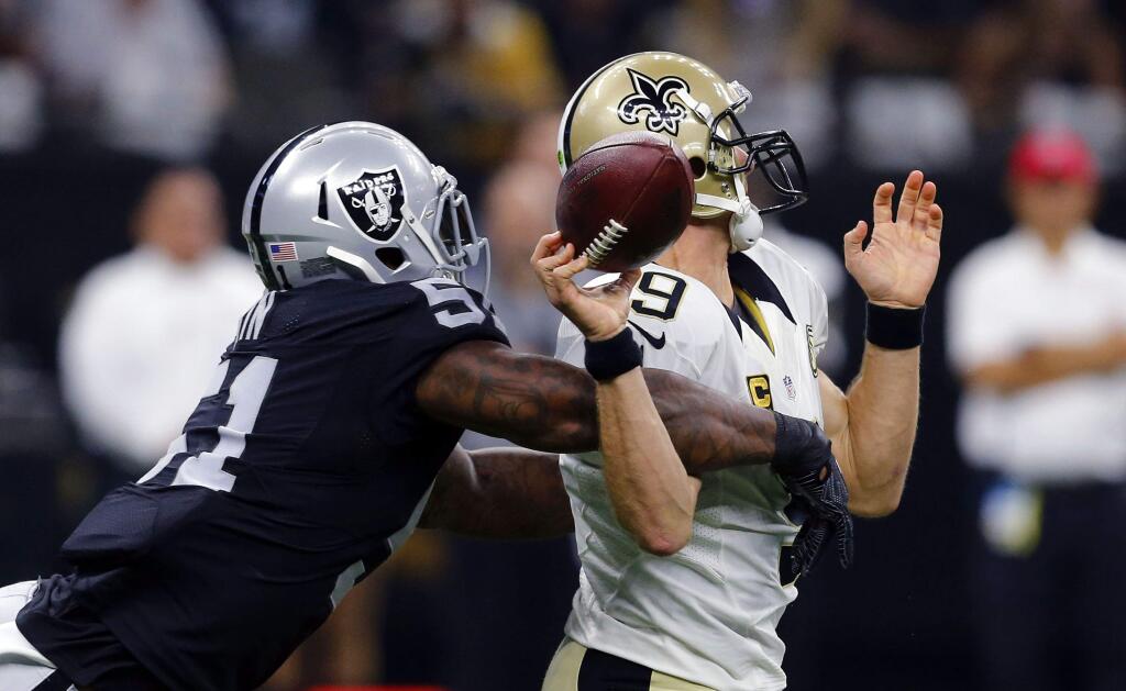 New Orleans Saints quarterback Drew Brees (9) fumbles as he is hit by Oakland Raiders linebacker Bruce Irvin (51) in the first half in New Orleans, Sunday, Sept. 11, 2016. (AP Photo/Butch Dill)