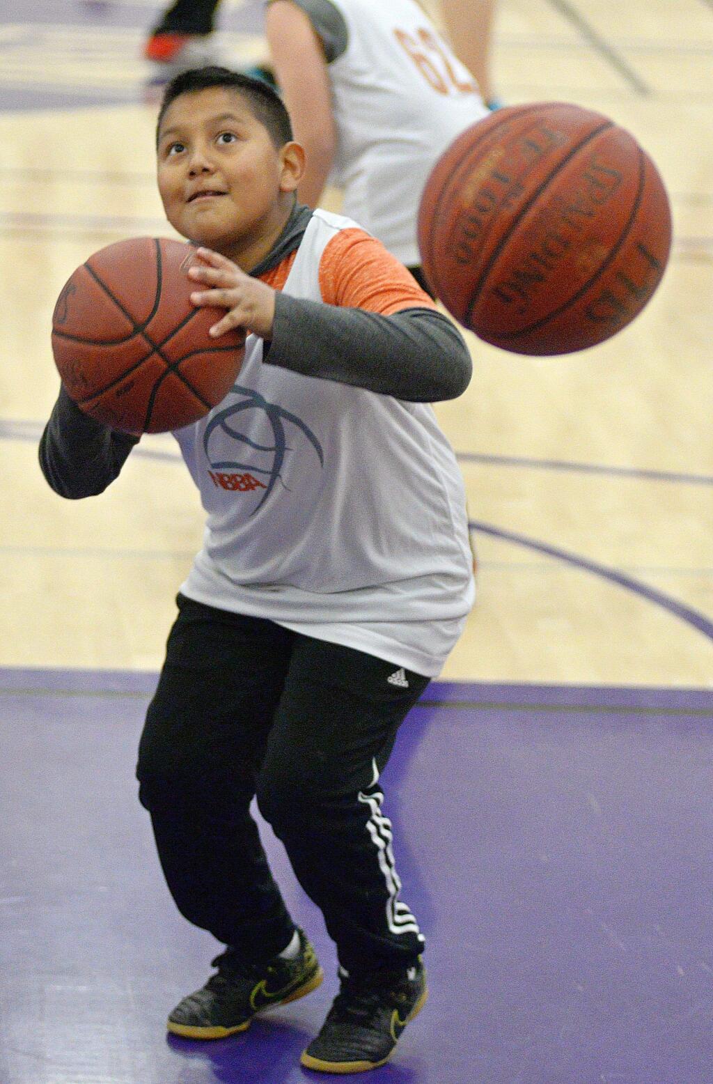 Incoming balls couldn't distract this shooter in warmups for a game in the Petaluma Basketball Jamboree for elementary schools sponsored by the Petaluma City Schools After Schools Activities Program and the Northbay Basketball Academy.(SUMNER FOWLER/FOR THE ARGUS-COURIER)