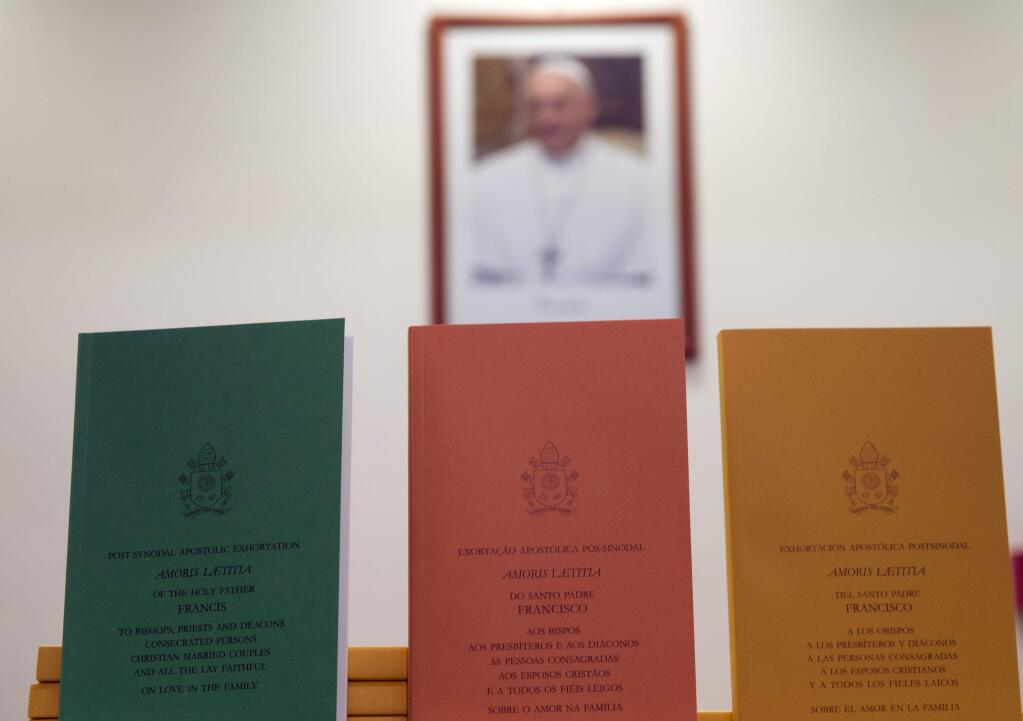 Copies of the post-synodal apostolic exhortation ' Amoris Laetitia ' (The Joy of Love) document are on display prior to the start of a press conference, at the Vatican, Friday, April 8, 2016. Pope Francis has insisted that individual conscience be the guiding principle for Catholics negotiating the complexities of sex, marriage and family life in a major document released Friday that repudiates the centrality of black and white rules for the faithful. In the 256-page document 'The Joy of Love,' released Friday, Francis makes no change in church doctrine. (AP Photo/Andrew Medichini)