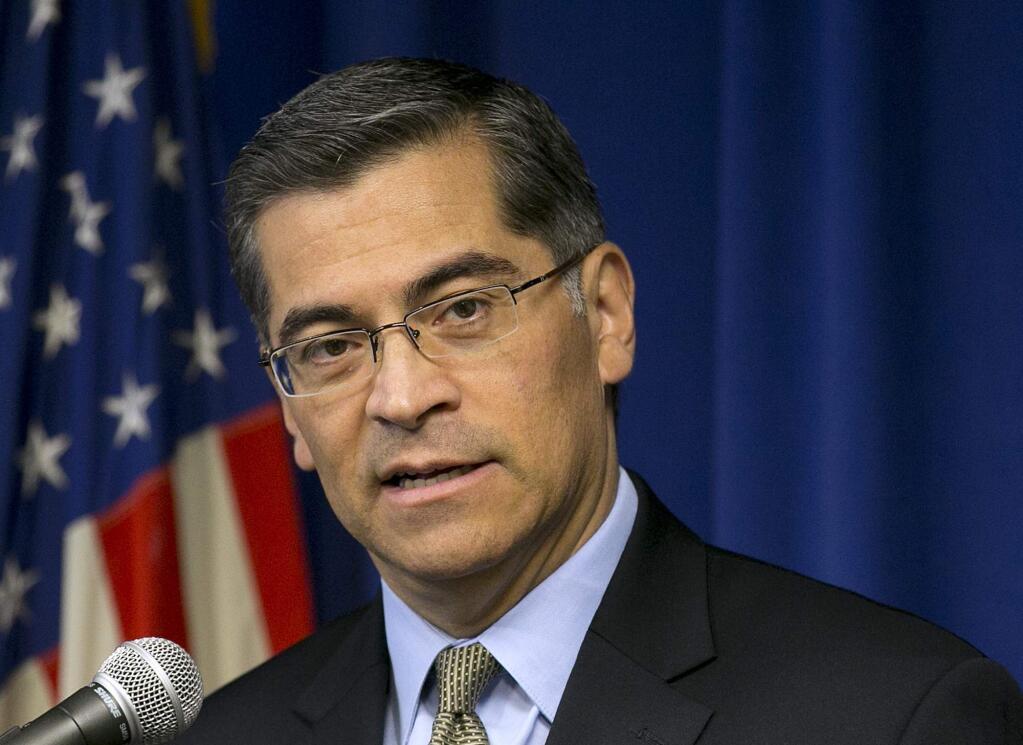 FILE - In this Jan. 24, 2018 file photo California Attorney General Xavier Becerra talks during a news conference in Sacramento, Calif. Becerra says his office will take over reviewing reforms at the San Francisco Police Department after the U.S. Department of Justice's decision to scale back a program that helped departments improve community relations. Becerra on Monday, Feb. 5, 2018, announced an agreement with San Francisco and its police department to evaluate the implementation of reforms recommended by DOJ under the Obama Administration. (AP Photo/Rich Pedroncelli,File)
