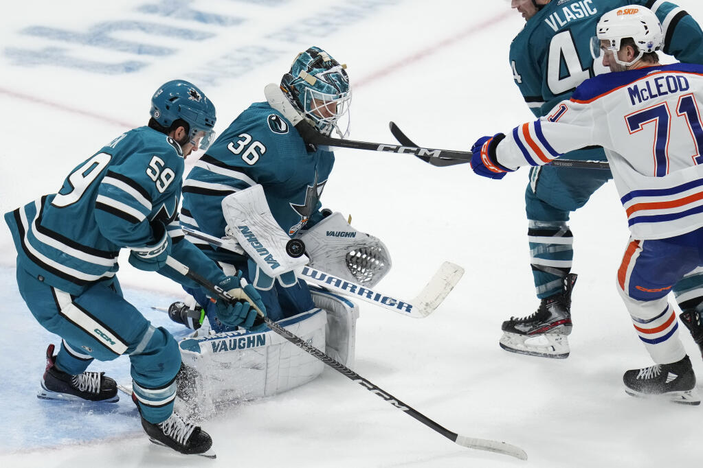 Sharks goaltender Kaapo Kahkonen, center, deflects an Edmonton Oilers shot during the third period Friday in San Jose. (Godofredo A. Vásquez / ASSOCIATED PRESS)