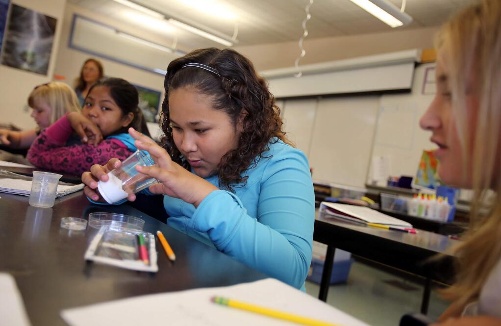 A student pokes her finger into a cup containing an absorbent synthetic polymer to make observations for a science experiment Monday during summer school in Sonoma. File photo.PC: Incoming sixth-grader Nicole Flores pokes her finger into a cup containing an absorbent synthetic polymer to make observations for a science experiment during Transitions Summer School at Adele Harrison Middle School, in Sonoma, on Monday, June 25, 2012.PC: