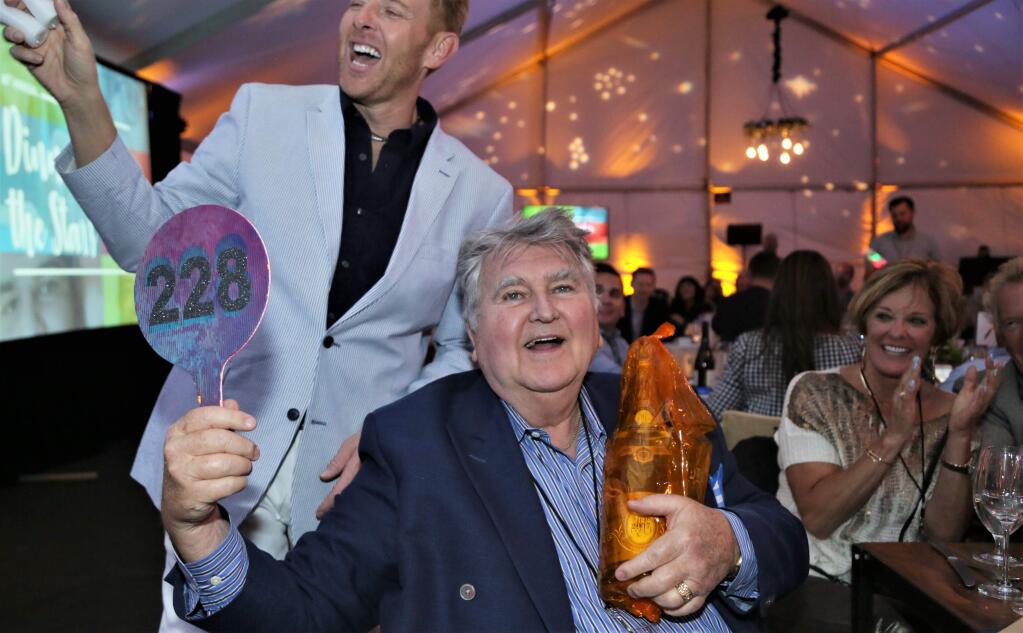 Gene Daly celebrates his winning bid for a magnum of Crystal Champagne at the Becoming independent Annual Gala on June 9, 2018 at Becoming Independent facilities in Santa Rosa, California. (WILL BUCQUOY/ FOR THE PD)