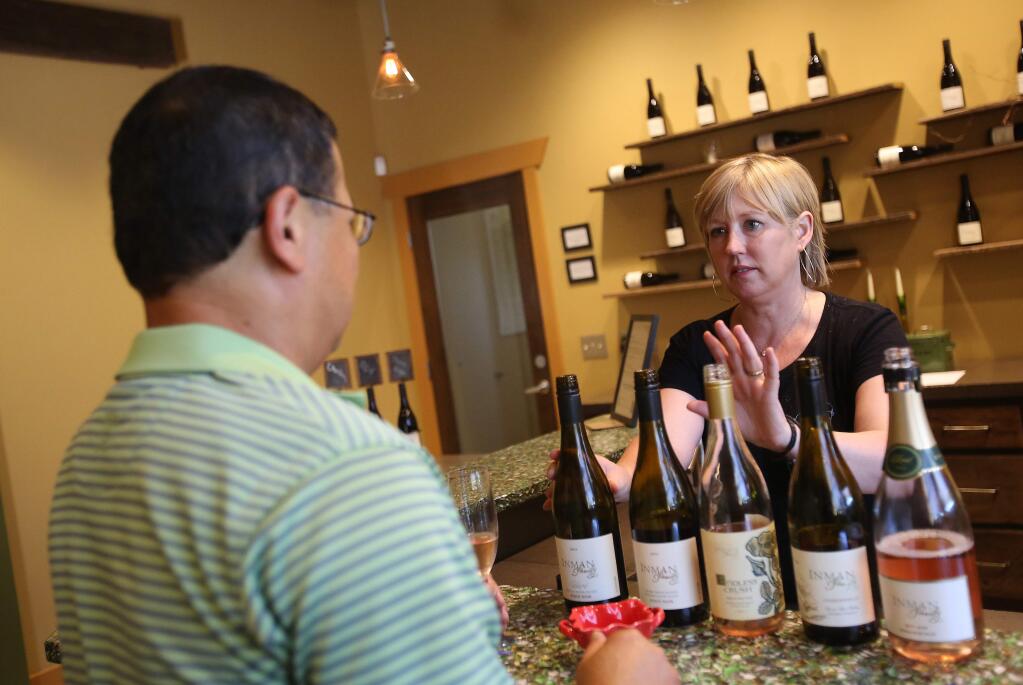 Kathleen Inman owner of Inman Family Wines, does a tasting with Richard Ow, of Santa Cruz, Thursday, July 31, 2014. (Crista Jeremiason / The Press Democrat)