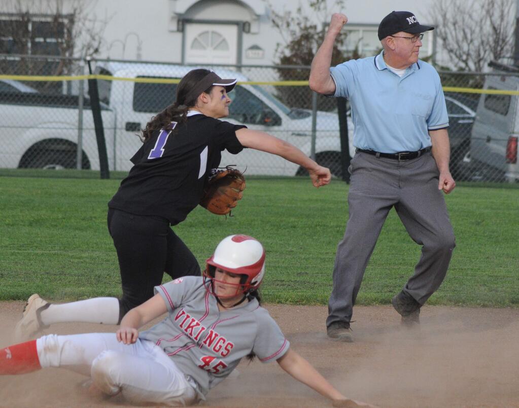 SUMNER FOWLER/FOR THE ARGUS-COURIERPetaluma shortstop Brie Gerhardt has a force out on Montgomery's Sophia Ramon and is trying for a double play. Umpire Don Phoenix makes the call.