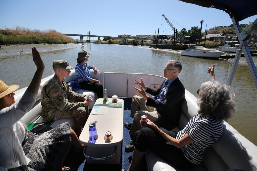 (From right) Elizabeth Howland, Treasurer of Friends of the Petaluma River, US Rep. Jared Huffman, Petaluma Mayor Teresa Barrett, US Army Corps of Engineers Lt. Col. John D. Cunningham, and Jenny Callaway, District Director for Rep. Huffman, tour the Petaluma River in a pontoon boat to discuss dredging and potential solutions to the long term maintenance of the river. Photo taken in Petaluma, California on Friday, August 2, 2019. (BETH SCHLANKER/The Press Democrat)