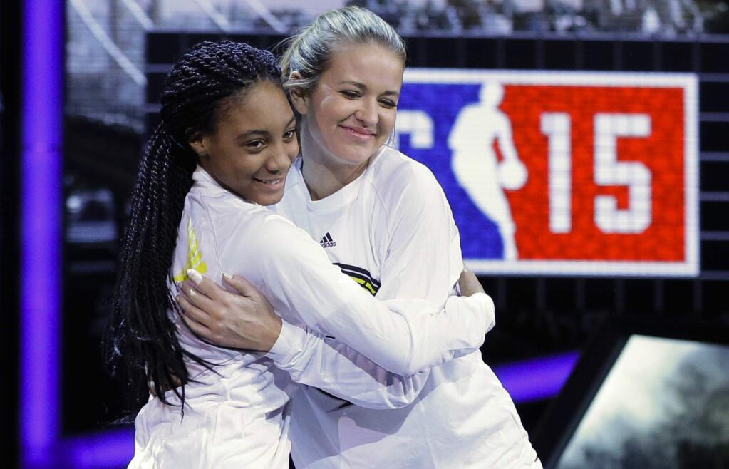 FILE - In this Feb. 13, 2015, file photo, Kristen Ledlow, right, hugs Mo'ne Davis as they are announced before the NBA All-Star celebrity basketball game in New York. Ledlow said on social media Oct. 23, 2016, that she was robbed at gunpoint. Ledlow is the host of 'NBA Inside Stuff' on NBA TV. (AP Photo/Frank Franklin II, File)