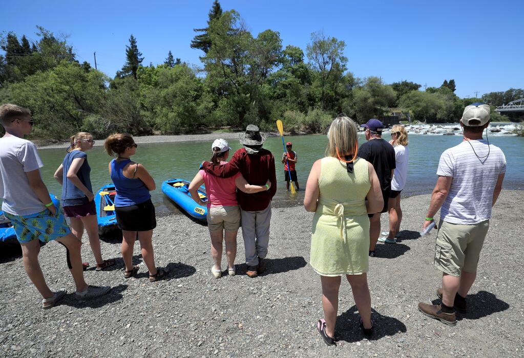 Boaters gather at Russian River Adventures and listen as Angel Martinez gives safety instructions, Thursday, May 30, 2019 in Healdsburg, prior to a an inflatable kayak ride downstream. (Kent Porter / The Press Democrat) 2019