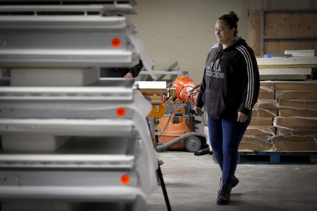 The tiny homes being built for the People’s Village at the Mary Isaac Center are being constructed by Quickhaven. Some of the employees of Quickhaven including Maria Colin, the shop lead pictured here Tuesday, March 15, 2022, were formerly homeless themselves. (CRISSY PASCUAL/ARGUS-COURIER STAFF)