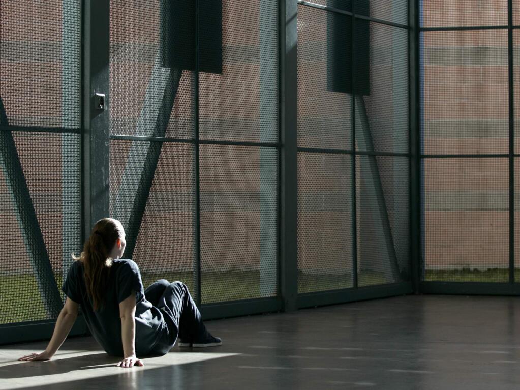 A female inmate gets a little bit of sun during a period of time out of her cell at the Sonoma County Main Adult Detention Facility in Santa Rosa,Thursday, March 3, 2011. (Beth Schlanker / The Press Democrat file)