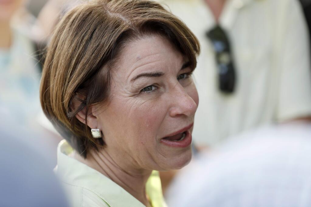 Democratic presidential candidate Sen. Amy Klobuchar speaks to reporters during the Hawkeye Area Labor Council Labor Day Picnic, Monday, Sept. 2, 2019, in Cedar Rapids, Iowa. (AP Photo/Charlie Neibergall)
