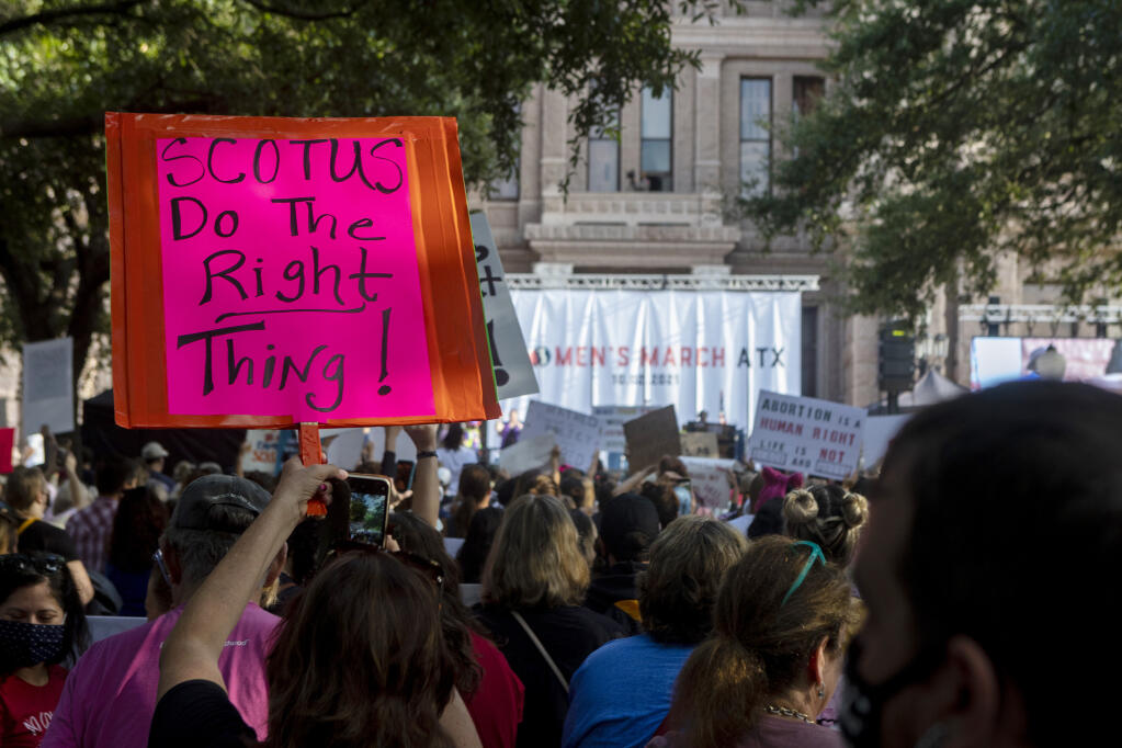 People attend the Women's March ATX rally, Oct., 2, 2021, at the Texas State Capitol in Austin, Texas. Yelp is the latest company to respond to a Texas law that bans abortions after about six weeks of pregnancy. (AP Photo/Stephen Spillman, File)