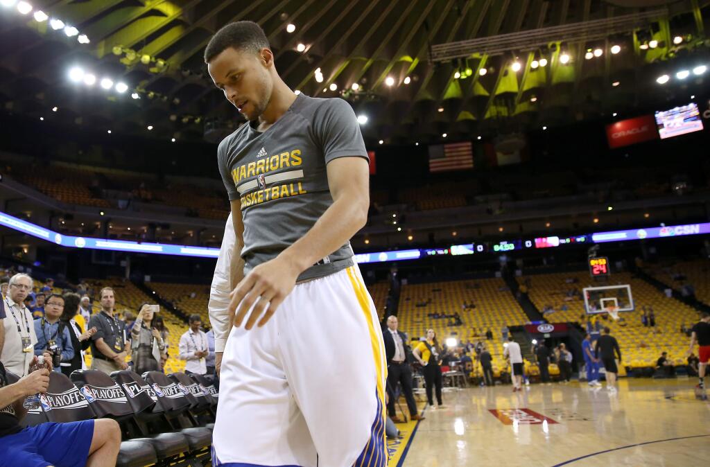 Golden State Warriors guard Stephen Curry leaves the court after cutting his warmup short before Game 2 against the Houston Rockets in Oakland on Monday, April 18, 2016. (Christopher Chung/ The Press Democrat)