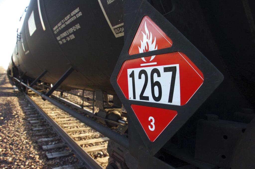 FILE - This Nov. 6, 2013 file photo shows a warning placard on a tank car carrying crude oil near a loading terminal in Trenton, N.D. BNSF Railway is regularly hauling three trains a week loaded with crude oil through the Sioux Falls, S.D., area, but those are the only shipments of crude from North Dakota's Bakken region crossing the state, according to records released by the South Dakota Department of Environment and Natural Resources Wednesday, July 9, 2014. (AP Photo/Matthew Brown, File)