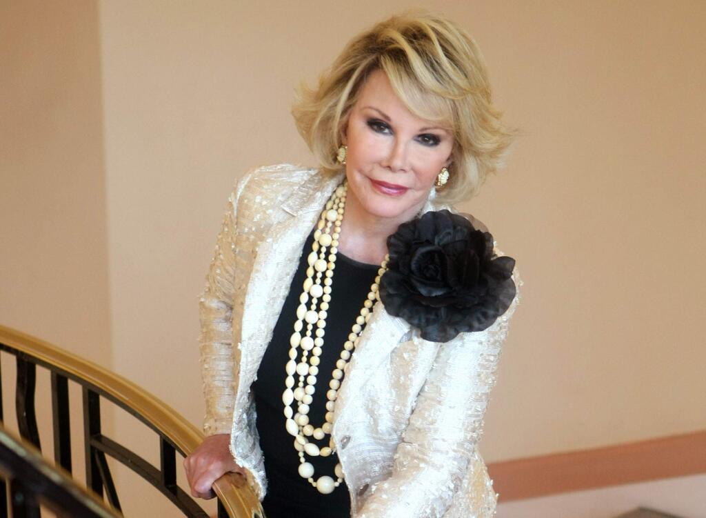 This Oct. 5, 2009 file photo shows Joan Rivers posing as she presents 'Comedy Roast with Joan Rivers ' during the 25th MIPCOM (International Film and Programme Market for TV, Video, Cable and Satellite) in Cannes, southeastern France. Rivers, the raucous, acid-tongued comedian who crashed the male-dominated realm of late-night talk shows and turned Hollywood red carpets into danger zones for badly dressed celebrities, died Thursday, Sept. 4, 2014. She was 81. Rivers was hospitalized Aug. 28, after going into cardiac arrest at a doctor's office. (AP Photo/Lionel Cironneau, File)