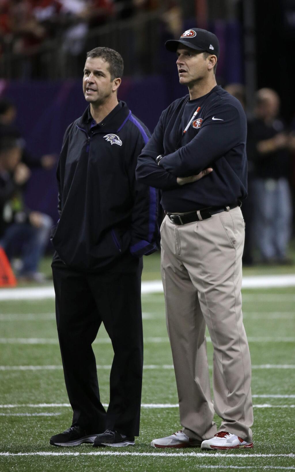 San Francisco 49ers head coach Jim Harbaugh, right, and Baltimore Ravens head coach John Harbaugh look on during warmups before the NFL Super Bowl XLVII football game, Sunday, Feb. 3, 2013, in New Orleans. (AP Photo/Matt Slocum)
