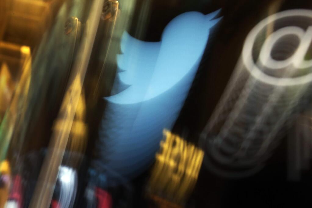 FILE - In this Wednesday Nov. 6, 2013, file photo, the Twitter logo appears on an updated phone post on the floor of the New York Stock Exchange. (AP Photo/Richard Drew, File)