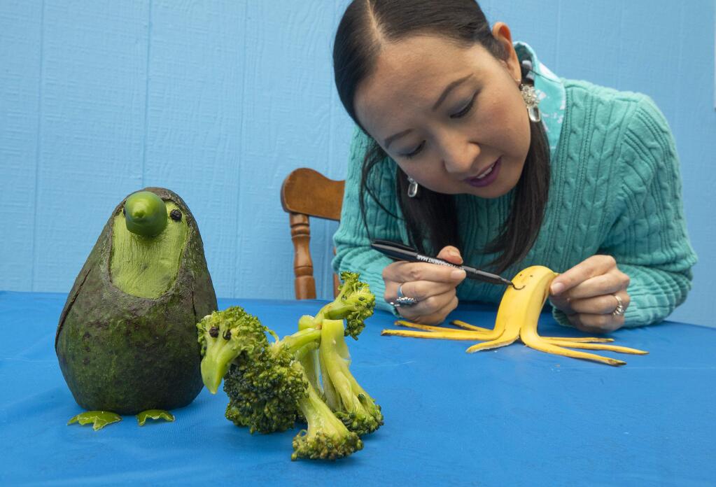 Kim Alvarez has used her time in quarantine to learn to make animals out of fruits and vegetables. From left, an avocado and jalapeño toucan, a broccoli poodle and a banana octopus. (John Burgess/The Press Democrat).