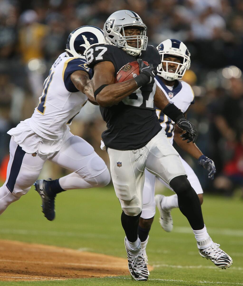 Oakland Raiders tight end Jared Cook makes a reception for 45-yards from quarterback Derek Carr against the Los Angeles Rams in Oakland on Monday, September 10, 2018. (Christopher Chung/ The Press Democrat)