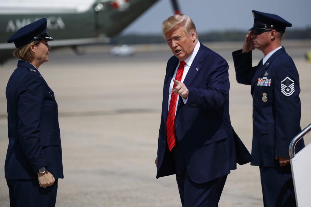 President Donald Trump points to reporters after arriving at Andrews Air Force Base, Thursday, Sept. 26, 2019, in Andrews Air Force Base, Md. (AP Photo/Evan Vucci)