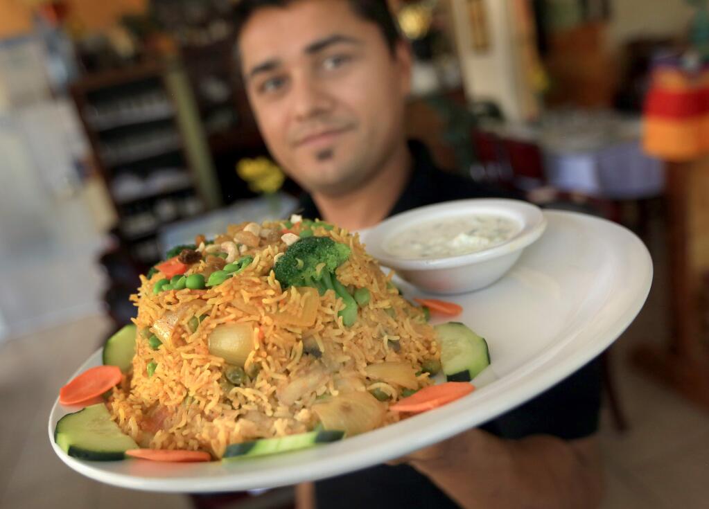 Chef manager Bishnu Pandey of Himalayan Restaurant of Windsor display's a Vegetable Himalayan Biryani, Wednesday April 22, 2015. (Kent Porter / Press Democrat) 2015