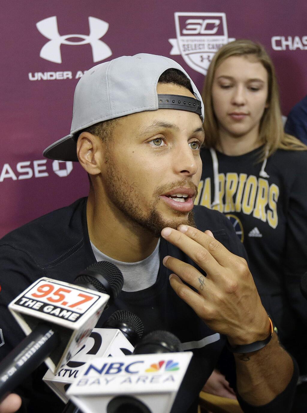 Golden State Warriors' Stephen Curry speaks to reporters at his basketball camp in Walnut Creek, Calif., Monday, Aug. 7, 2017. (AP Photo/Jeff Chiu)