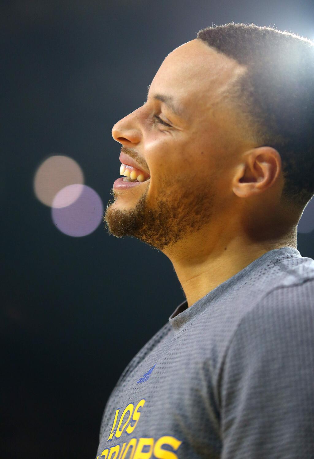 Golden State Warriors guard Stephen Curry laughs during warmups before facing the Boston Celtics in Oakland on Wednesday, March 8. (Christopher Chung/ The Press Democrat)