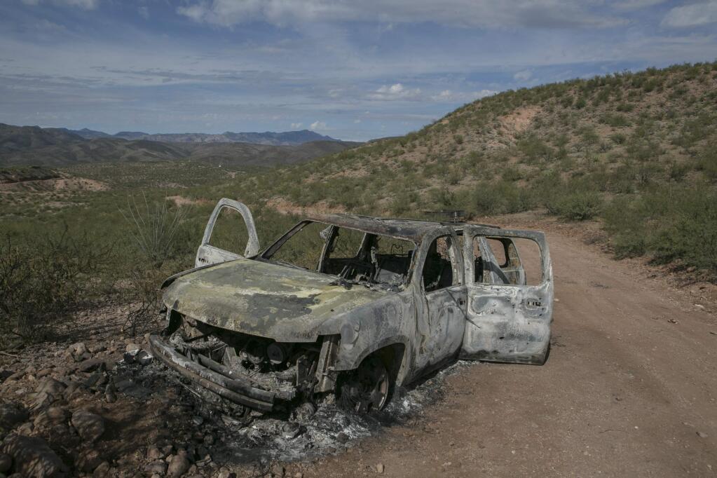 The burned SUV in which Rhonita Miller and four of her children were killed on Nov. 6 in an ambush, sits near La Mora, Mexico. Mexican authorities believe the attack was related to battles between rival drug gangs. (MEGHAN DHALIWAL / New York Times)