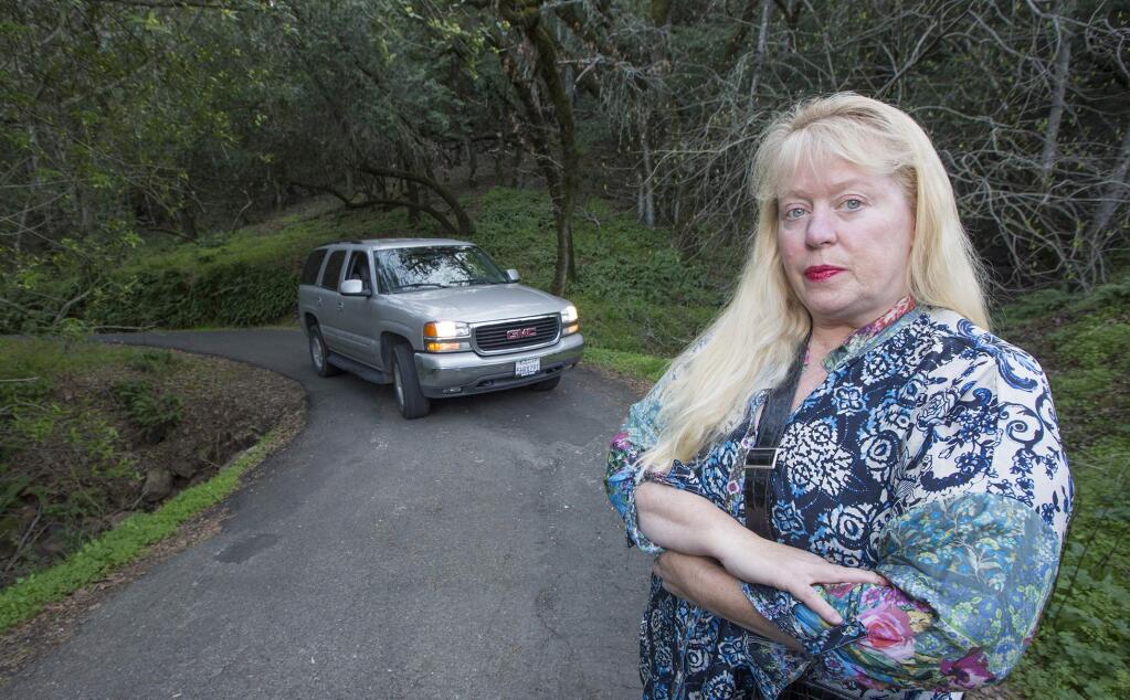 Morningside Mountain resident Susan Costello on winding, unlit Vigilante Rod, barely wide enough for a single vehicle. The neighborhood is seeking X Zone status to exclude further vacation rental permits. (Photo by Robbi Pengelly/Index-Tribune)