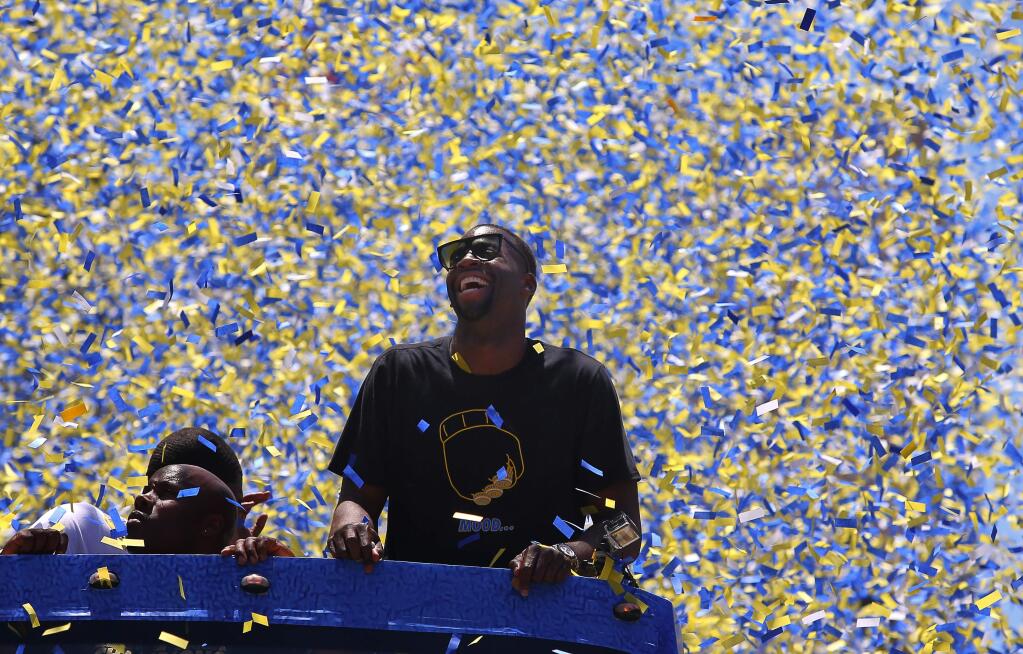 Warriors forward Draymond Green is showered with confetti, during the team's victory parade in Oakland on Tuesday, June 12, 2018. (Christopher Chung/ The Press Democrat)