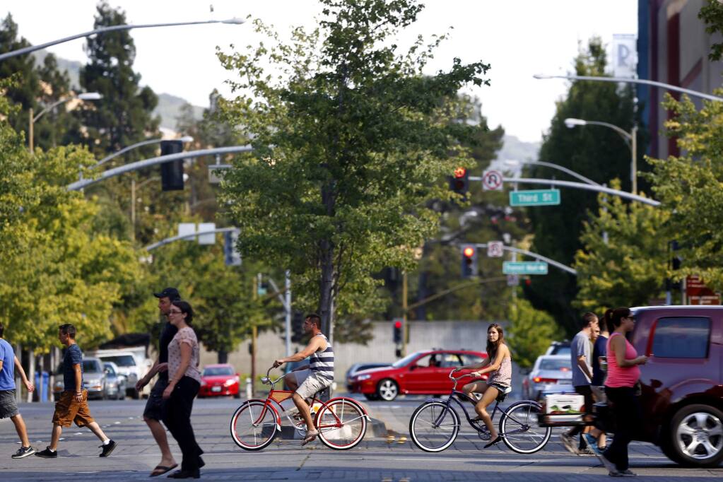 Pedestrians, cyclists and motorists cross Mendocino Avenue at Fourth Street next to Old Courthouse Square in Santa Rosa on July 13, 2014. (BETH SCHLANKER/ The Press Democrat