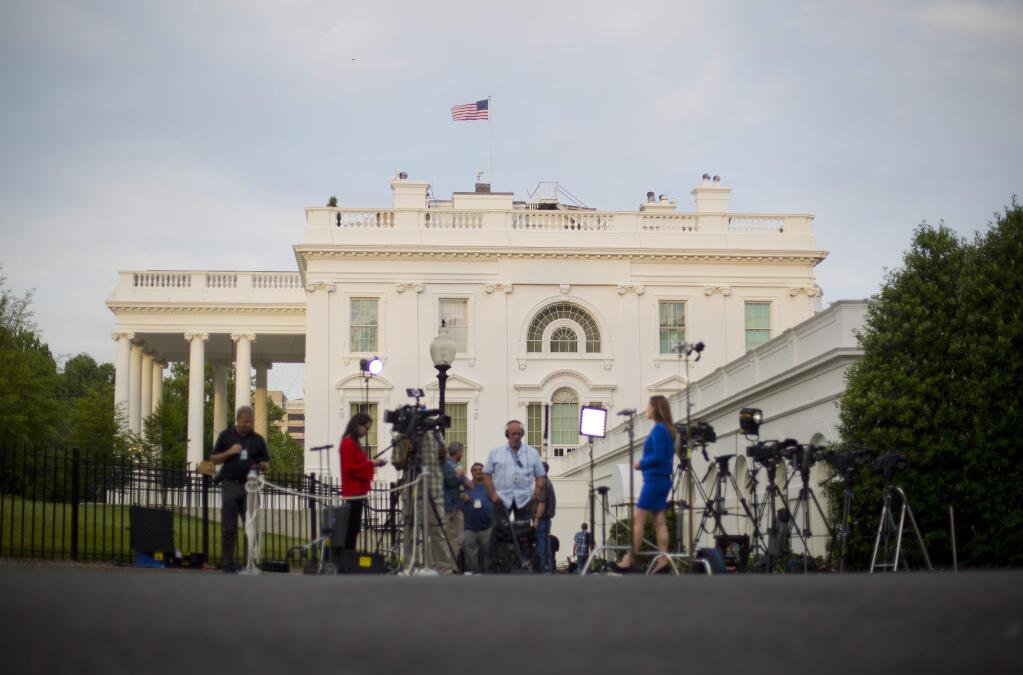 Television network crews begin their evening news broadcast from the driveway outside the West Wing of the White House in Washington, Wednesday, May 17, 2017. The Justice Department has appointed former FBI Director Robert Mueller as a special counsel to oversee a federal investigation into potential coordination between Russia and the Donald Trump campaign to influence the 2016 presidential election.(AP Photo/Pablo Martinez Monsivais)