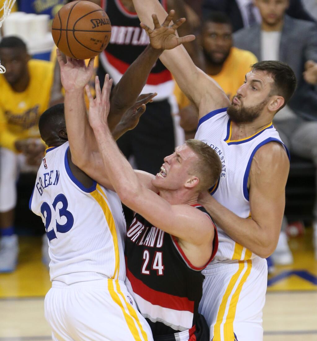 Golden State Warriors defenders Draymond Green and Andrew Bogut close in on Portland Trail Blazers' Mason Plumlee, during their game in Oakland on Tuesday, May 3, 2016. The Warriors defeated the Trail Blazers 110-99. (Christopher Chung/ The Press Democrat)