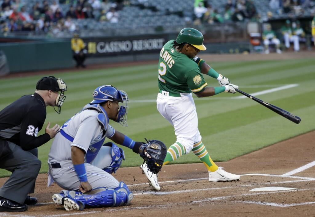 Oakland Athletics' Khris Davis, right, hits a solo home run against the Kansas City Royals during the first inning of a baseball game Friday, June 8, 2018, in Oakland, Calif. (AP Photo/Marcio Jose Sanchez)