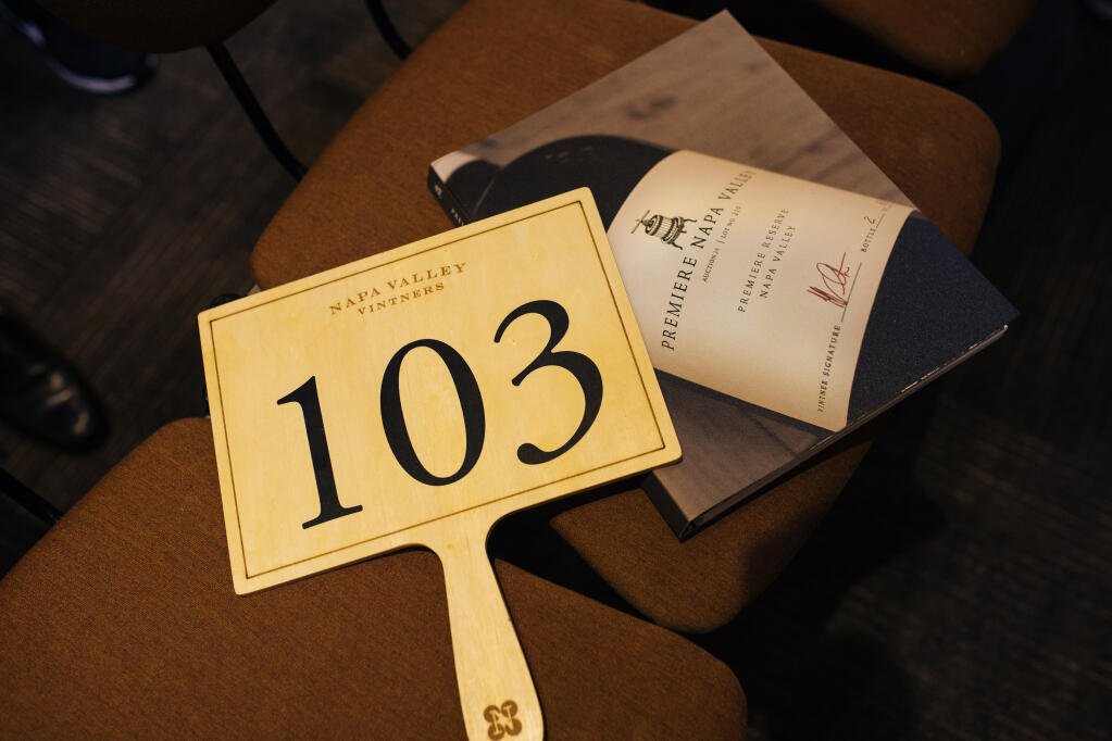 An auction paddle and lots pamphlet sit on chairs during the Premiere Napa Valley event in February 2020. Because of COVID-19, the event is rescheduled for June 2021. (Alexander Rubin / for Napa Valley Vintners)