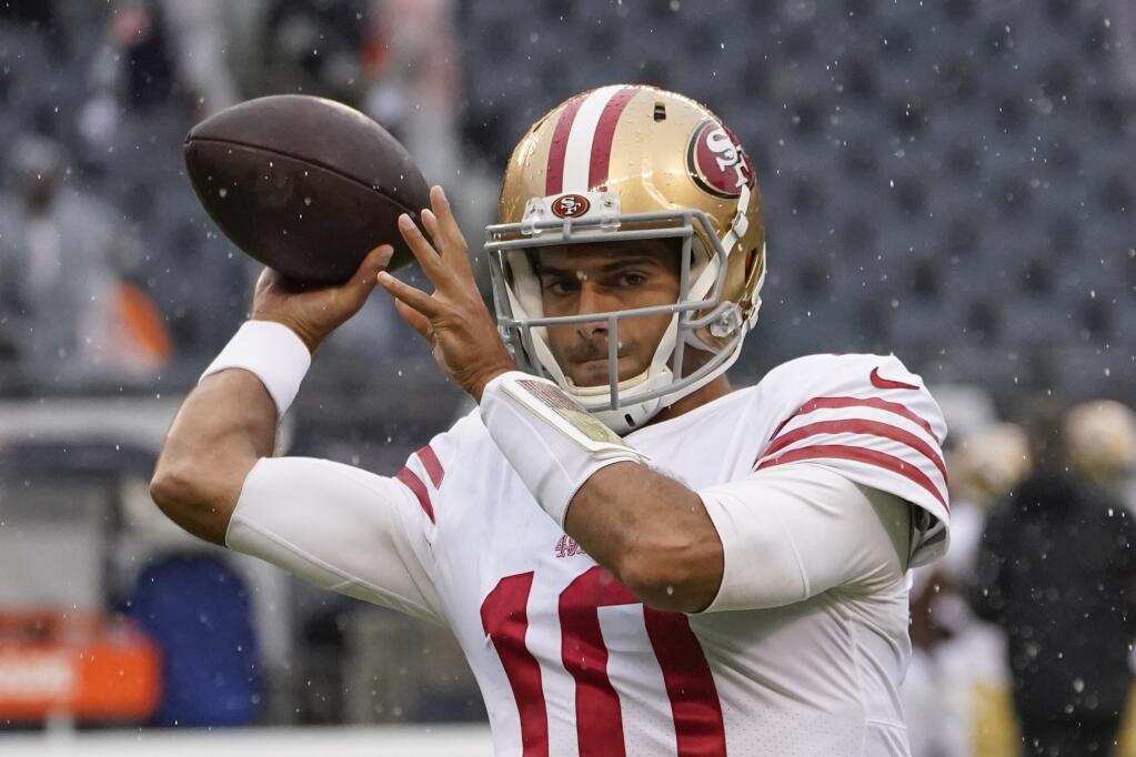The 49ers’ Jimmy Garoppolo warms up before Sunday’s game against the Bears in Chicago. (Charles Rex Arbogast / ASSOCIATED PRESS)
