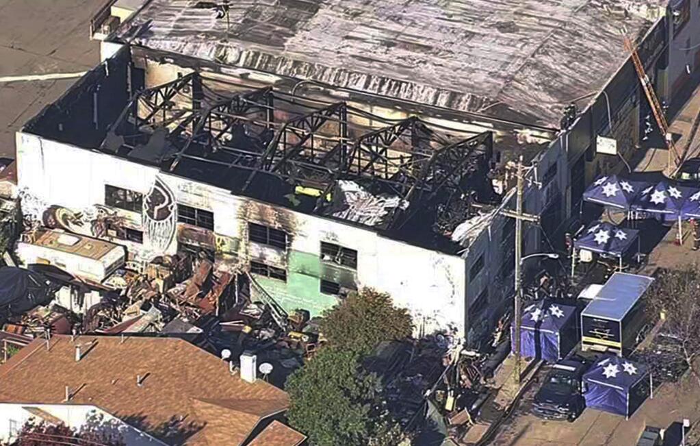 FILE- This Dec. 3, 2016, file image from video provided by KGO-TV shows the Ghost Ship Warehouse after a fire swept through the building in Oakland, Calif. The one-year anniversary of the deadliest building fire in the U.S. in more than a decade is bringing back painful memories for victims' families. It's also refocusing attention on Oakland, California, where the blaze occurred. Some critics say the beleaguered city hasn't moved quickly enough to prevent a similar tragedy. (KGO-TV via AP, File)