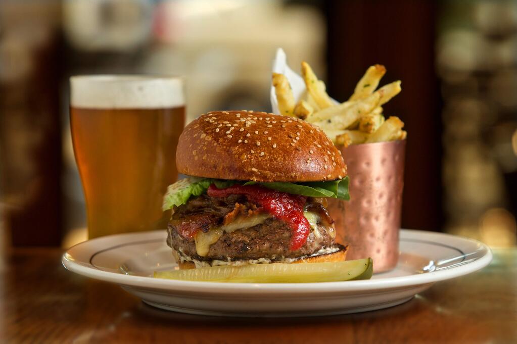 Beefa Spring Burger with slow-cooked onion, bacon, cheddar, summer truffle aioli and Kennebec fries from the Brass Rabbit in Healdsburg. (JOHN BURGESS/ PD)